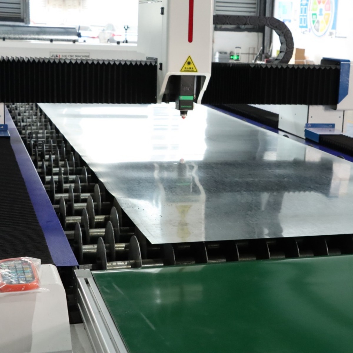 Fiber Laser Cutting Head Close-Up with Metal Sheet